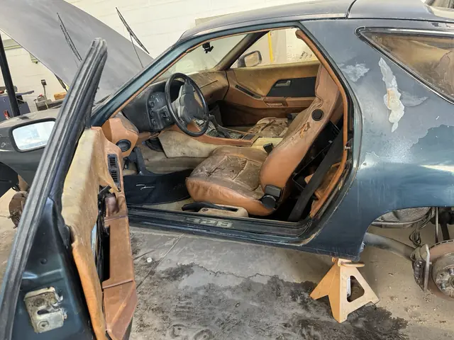 Worn tan seats through the driver's door